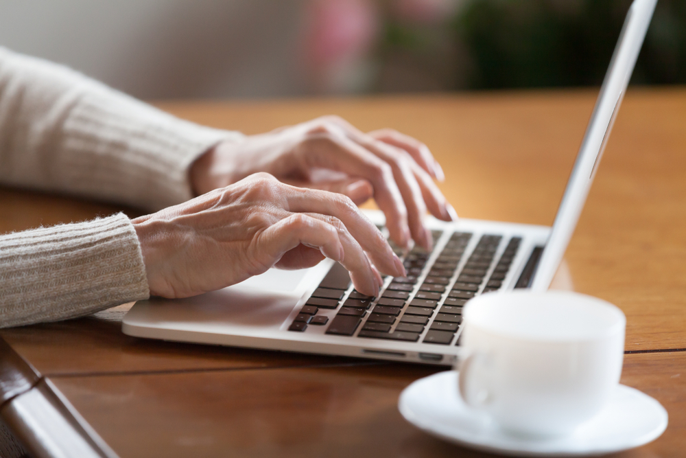 Senior woman typing on a computer